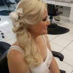 Wedding hair with flower accessory side half updo by Les Ciseaux St. Armands