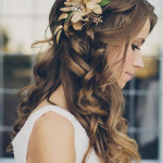 Wedding hair style long curl with flower accessory by Les Ciseaux St. Armands